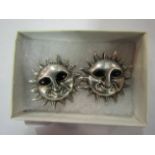 A pair of Mexican silver sun stud earrings with enamel eyes,