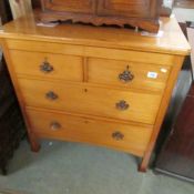 A light wood 2 over 2 chest of drawers.