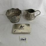 An Indian silver sugar bowl and milk jug together with a cigarette case.