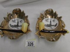 A pair of 1920s gilded porcelain pip ashtrays depicting Boston Stump church.