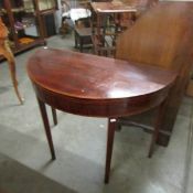 A D shaped mahogany fold over table.