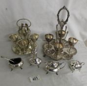 2 silver plate egg cup stands, a 3 piece condiment set and a mustard pot.