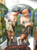 A pair of children statues.