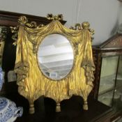 An unusual gilt framed mirror.