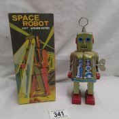 A tinplate clockwork space robot in original box.