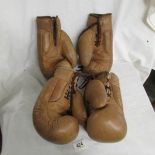 2 pairs of old leather boxing gloves.