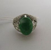 A 3.5 carat oval emerald and 88 point baguette and brilliant diamond high carat white gold ring,