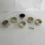 5 silver napkin rings together with a silver salt complete with blue glass liner and spoon.