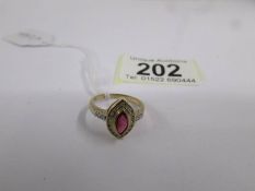 A 9ct gold ring set central ruby and diamonds, size M half.