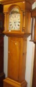 A pine cased Grandfather clock with battery movement.