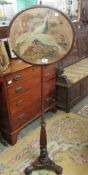 A Victorian mahogany pole screen with tapestry panel depicting game bird.