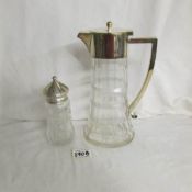 A glass sugar sifter with silver top and a glass claret jug with plated top.