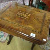 A mid-Victorian walnut sewing table with inlaid fold-over games compendium table-top for chess,