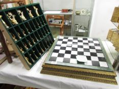 A good quality chess set with Egyptian style figures (one knight is missing figure).