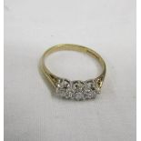 A diamond three stone brilliant cut ring in a 9ct gold shank, size N.