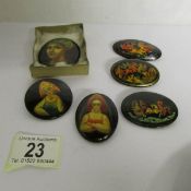 6 hand painted, signed and titled Russian lacquered brooches.