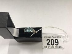 A blue topaz 3 stone ring in 9ct gold,. size S.