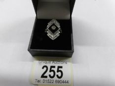 A platinum ring set large onyx and diamonds, size N.