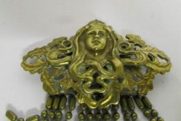 An Art Nouveau style metal brooch marked style metal spec. NY.