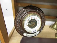 An Edwardian circular carved aneroid barometer.