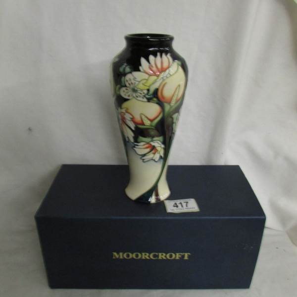 A boxed Moorcroft baluster vase, 21 cm tall.