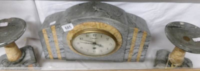 A 3 piece marble clock set.