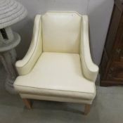 A classical designed leather style comfy armchair in soft beige.