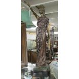 A bronze figure of a lady.