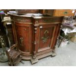 A Victorian marble top credenza with cherub depictions 2 side doors, in need of some restoration.