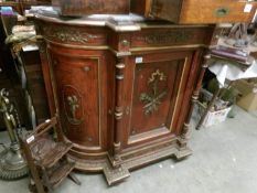 A Victorian marble top credenza with cherub depictions 2 side doors, in need of some restoration.