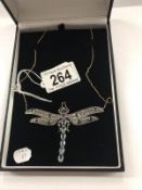 A superb quality dragonfly pendant set sapphires, rubies, aquamarine etc., on an 18ct gold chain.