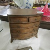 A small (tradesman's) mahogany bow front chest of drawers on splay bracket feet.