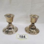 A pair of hallmarked silver candlesticks.