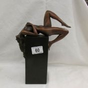 A designer bronze figurine of a naked female on a bronze base, approximately 29 cm tall.