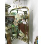 A brass fire screen with floral painted mirror inset.