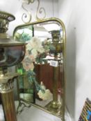 A brass fire screen with floral painted mirror inset.