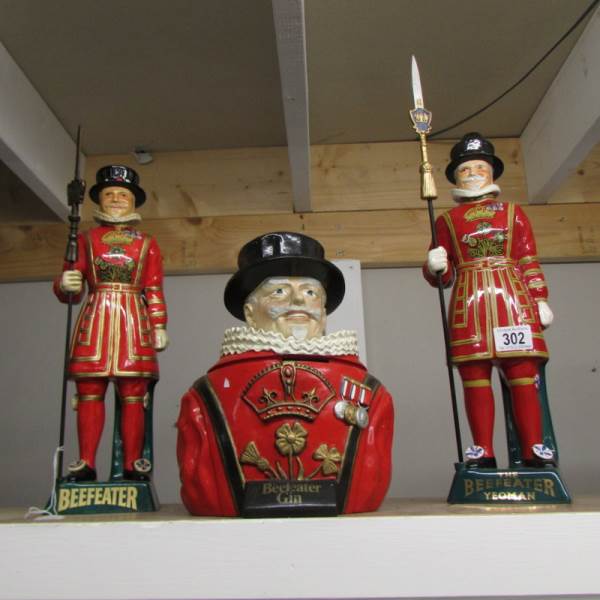 A Beefeater gin ice bucket and 2 Beefeater figures.