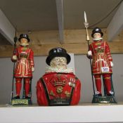 A Beefeater gin ice bucket and 2 Beefeater figures.