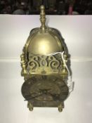 A brass lantern clock.