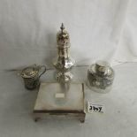 A silver plate sugar sifter, cigarette box, bottle and salt.