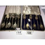 2 cased sets of golf related silver teaspoons.