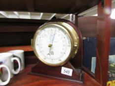 A brass ship's barometer.