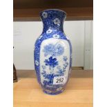 A blue and white Oriental vase with floral depictions and 6 character marks to base,