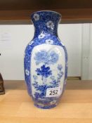 A blue and white Oriental vase with floral depictions and 6 character marks to base,