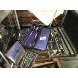 A cased collection of various mathematical instruments.