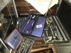 A cased collection of various mathematical instruments.