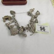 A superb circa 1970s silver charm bracelet with 11 charms including 4 opening charms,