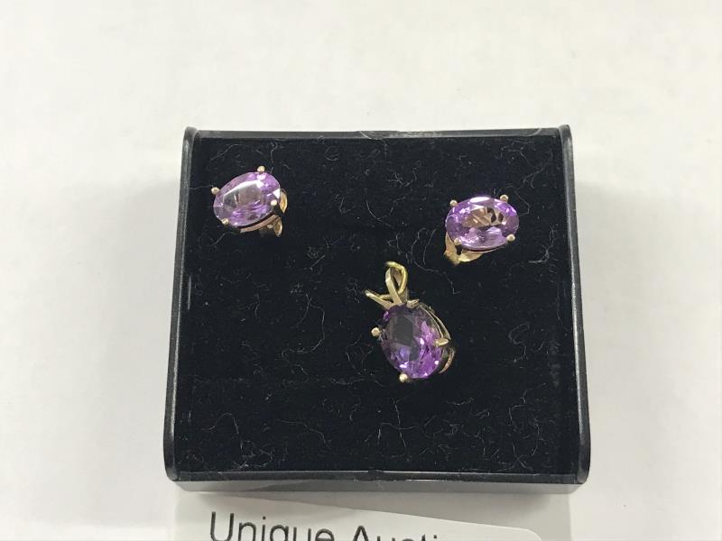 A 9ct gold pendant set amethyst with matching ear studs. - Image 2 of 2