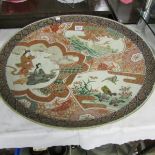 An early 19th century Japanese charger with depictions of people, dragon, flora and fauna recto,