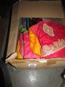 A large box of Indian saris etc.